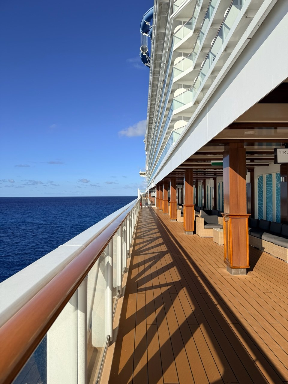 A sunlit cruise ship deck overlooking the sea